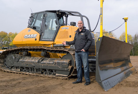 Photo: Eric Nettleton, global product marketing manager for CNH Construction Equipment, describes the features of the Case 2050M dozer at a press event in Tomahawk, Wis. The 2050M, the largest dozer in the new line, is geared to the aggregates/mining market.