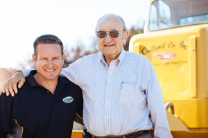 Owners Marv Soiland and his son Mark pose in front of the company’s very first tractor.