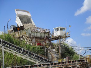 A haul truck loads material into a crusher.