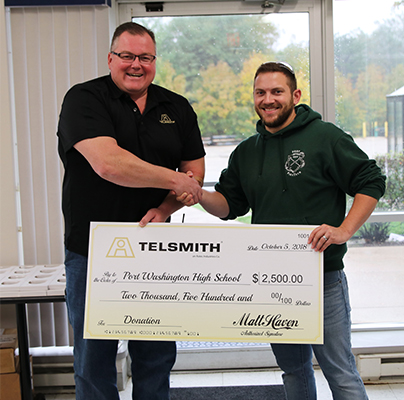 Brian Taylor, left, Director of Manufacturing for Telsmith, presents the donation to Taylor Last, right, Port Washington High School Technology Education and FIRST Robotics Team coach. Photo courtesy of Telsmith