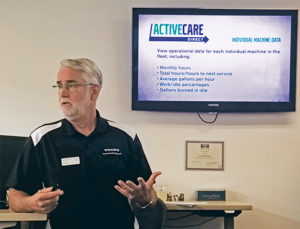 Jim Bretz, director of uptime and connected services at Volvo CE, dives into ActiveCare Direct during this fall’s trade press event. Photo: Kevin Yanik