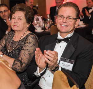 Manfred son, Peter, right, and Manfred’s wife, Christina were among those in attendance at the Pit & Quarry ceremony in support of the Polydeck co-founder. Photo by PamElla Lee Photography.