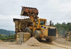 A 988F wheel loader feeds the 42-in. jaw crusher at Magruder Limestone. Production manager Clark Bollinger prefers to keep the loader within 500 ft. of the face at all times. Photo by Kevin Yanik