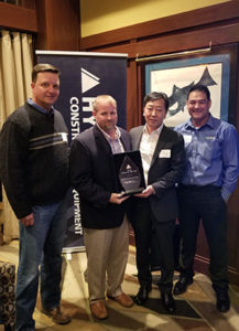 From left: HCEA's Shaun Galligan, NED's Jason Wainwright, HCEA's M.S. Kang and HCEA's Eli Bello celebrate NED's Dealer of the Year award. Photo courtesy of HCEA