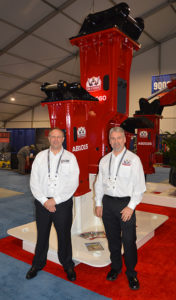 Allied Pedestal Boom Systems' Chris Cadnum, left, with Kevin Loomis in front of a new Rebel Attachments hammer. Photo: P&Q Staff