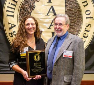 LafargeHolcim’s Becky Kazmierski, left, presents a plaque to Donald Mikulic during the IAAP Annual Convention. Kazmierski serves IAAP as chairperson of its Public Information & Education Committee. Photo: IAAP