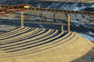A Luck Stone Atlanta-Stephens Plant associate inspects the quality of the 89 product as it is conveyed into a stockpile. Photo: Luck Companies