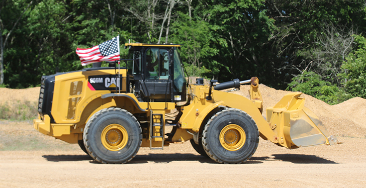 Mississippi-based Hammett Gravel Co. fastened American flags on its fleet of mobile equipment, including this Cat 966M wheel loader. Photo: Hammett Gravel