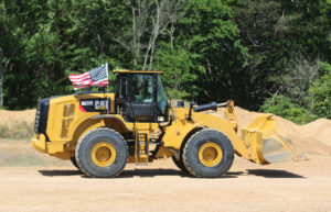 Mississippi-based Hammett Gravel Co. fastened American flags on its fleet of mobile equipment, including this Cat 966M wheel loader. Photo: Hammett Gravel