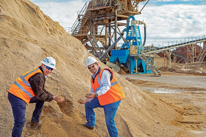 Curtis Wheatcraft, right, shows off some of the additional sand Wheatcraft Materials is capturing alongside CDE’s Tom Wick. Photo: CDE