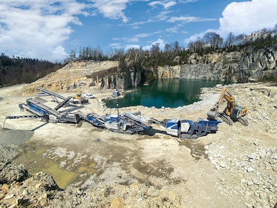 High performance as a team: The cone crusher MOBICONE MCO 90(i) EVO2 and the jaw crusher MOBICAT MC 110(i) EVO2 in line coupling with a screening plant and a stacker. Photo: Kleemann
