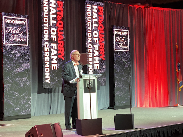 John Baker speaks at the Pit & Quarry Hall of Fame Induction Ceremony on behalf of his brother, Ted Baker, a member of the 2022 Hall of Fame class. Photo: P&Q Staff