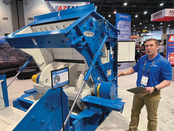 Stedman Machine Co.’s Colby Bowman offered a rundown of the Grand Slam horizontal shaft impactor during a press event at ConExpo-Con/Agg. Photo: P&Q Staff