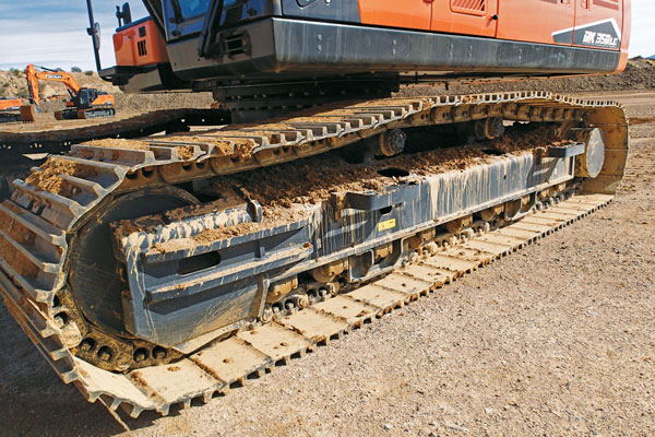 Maintaining a clean undercarriage is vital to safeguarding track components from abrasive materials and minimizing wear. Photo: Doosan