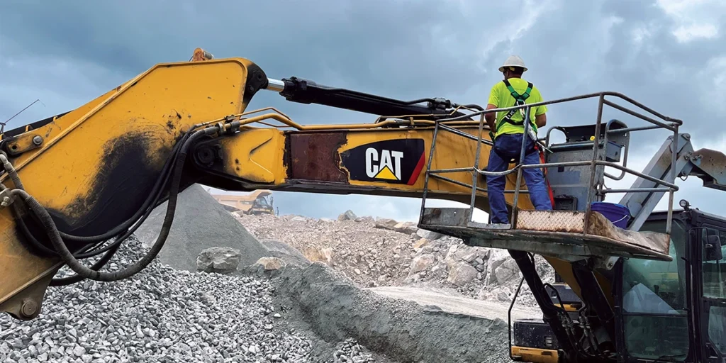 The worker seen here is wearing fall protection in an aerial lift to fix a hydraulic leak. (Photo: Steve Fuller)