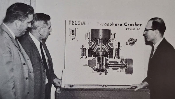Ron DeDiemar, pictured at right while serving as manager of Telsmith Machine Design, explained the finer points of the company’s Gyrasphere crusher during this industrial sales meeting. Photo: Jeanette DeDiemar