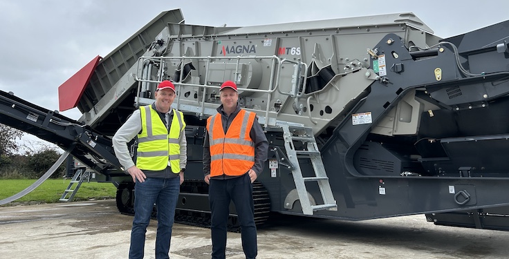 Colm McGuckian, director of aggregates and material processing for RTL Equipment, and Neil McIlwaine, business line director at Magna, stand in front of a Magna MT6S destined for the U.S. market. Photo: Magna