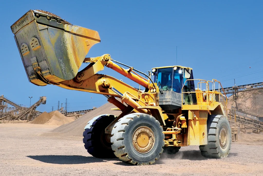 A wheel loader moves material at a quarry site. Loaders offer mobility and versatility, often serving in load-and-carry applications between the muckpile and crushers. (Photo: P&Q staff)