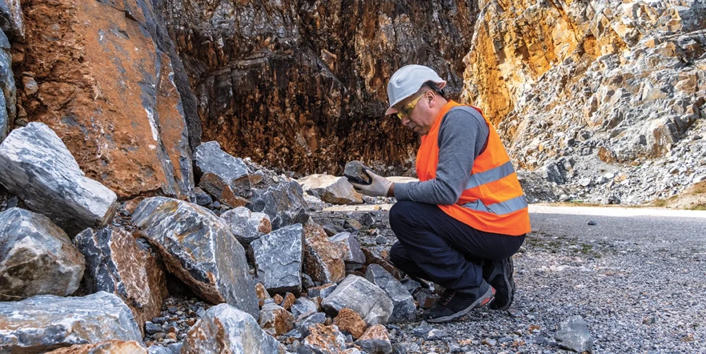 Geologist examining rock at a site