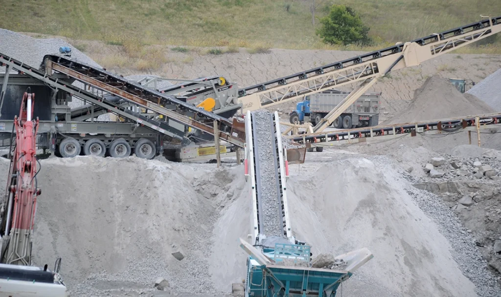 Photo of multiple conveyors transfering material between portable plants