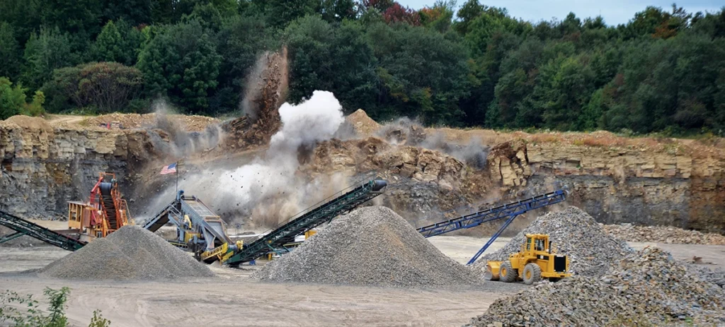 Photo of a blast taking place adjacent to processing equipment illustrates the need for careful planning and safety.