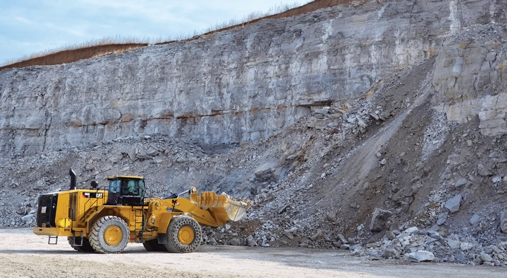 Photo of a wheel loader working a muckpile created by a blast.