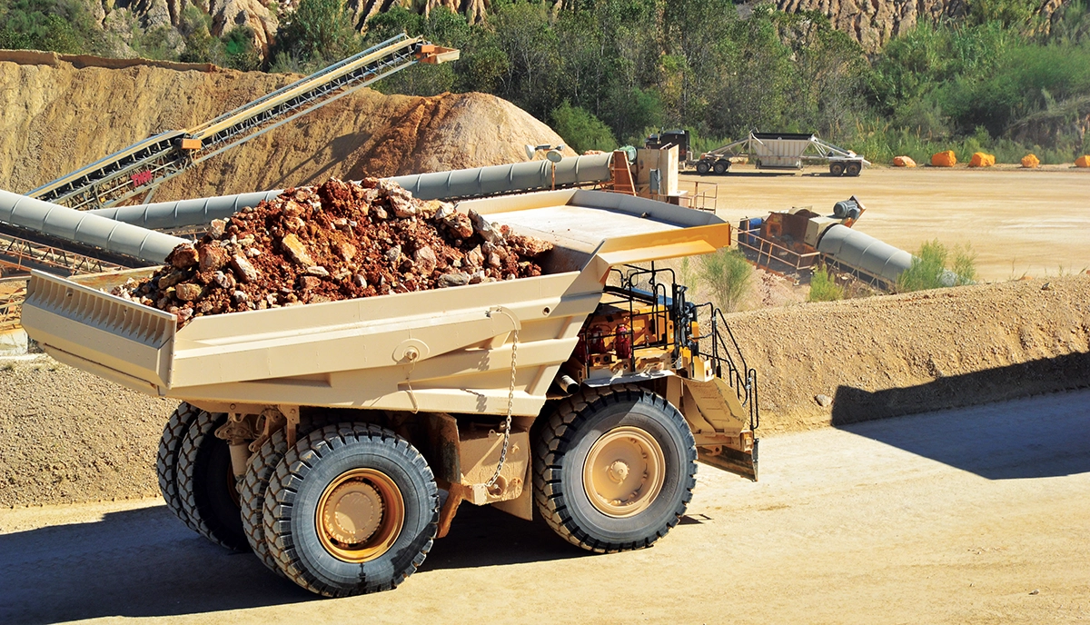 Photo of a loaded haul truck driving along a road