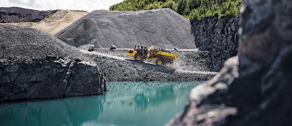Photo of an articulated hauler maneuvering through a quarry
