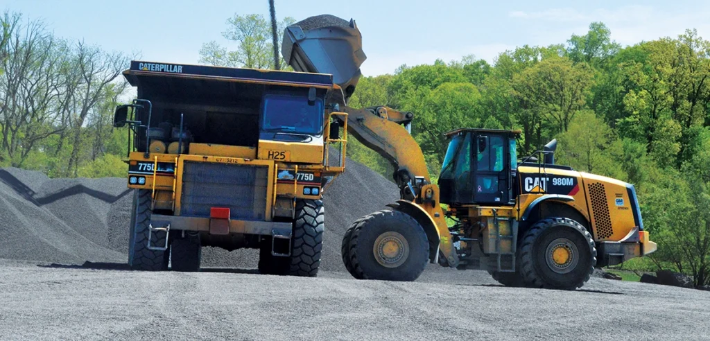 Photo of a haul truck and a loader
