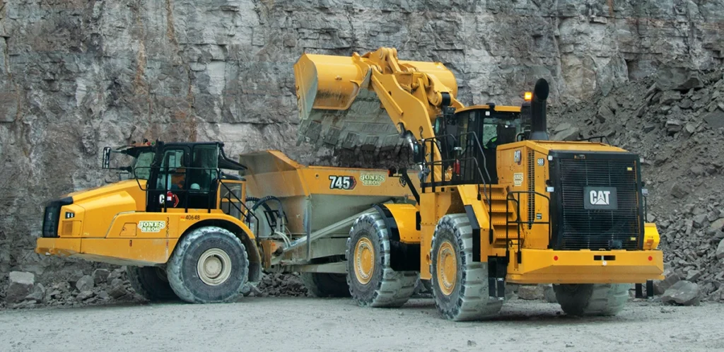 Photo of a haul truck and a loader