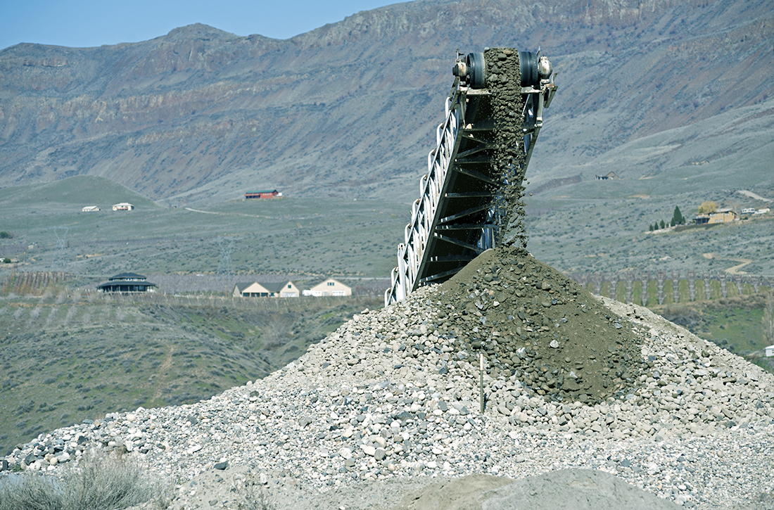 Rocks fall from a conveyor belt onto a pile at gravel pit in central Washington state. (Photo: PhilAugustavo/iStock / Getty Images Plus/Getty Images)