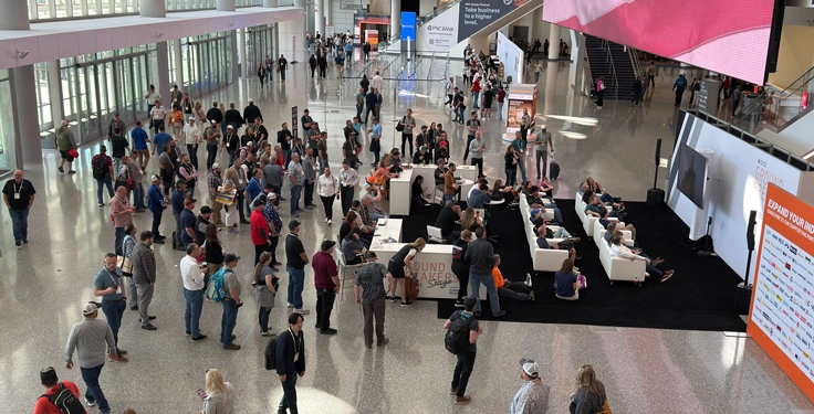 ConExpo-Con/Agg attendees in the West Hall watched a broadcast of an interview taking place on the Ground Breakers Stage during the third day of the show on Thursday. (Photo: P&Q Staff)